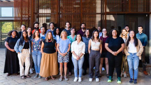 A group photo of smiling Switzer Fellows standing in front of a metal structure.