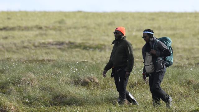 Nigel Golden walks with one of his students to a field site on the tundra. 