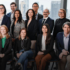 A group photo of the 2023 Skadden Fellows, with logo and learn more links superimposed