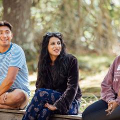 Switzer Fellows sit on a bench smiling