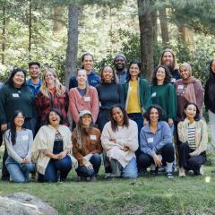 Switzer Fellows pose with big smiles in a forest
