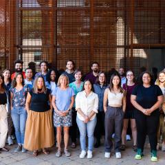 A group photo of smiling Switzer Fellows standing in front of a metal structure.