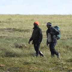 Nigel Golden walks with one of his students to a field site on the tundra. 
