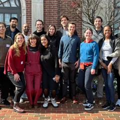 A group photo of Switzer Fellows standing in a brick courtyard.