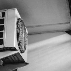 A black and white photo of a wall mounted air conditioner.