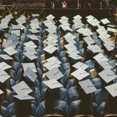 Rows of graduation caps seen from above. 