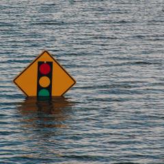 A street sign pokes out of flood waters