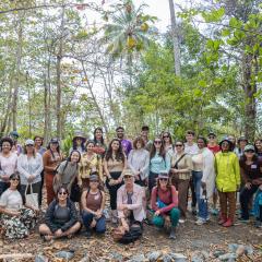 A group photo of Fellowship to Friendship participants standing in the forest.