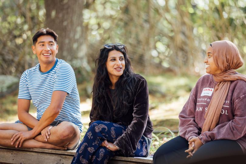 Switzer Fellows sit on a bench smiling