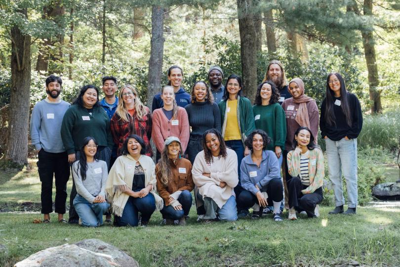 Switzer Fellows pose with big smiles in a forest