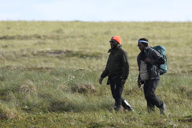 Nigel Golden walks with one of his students to a field site on the tundra. 