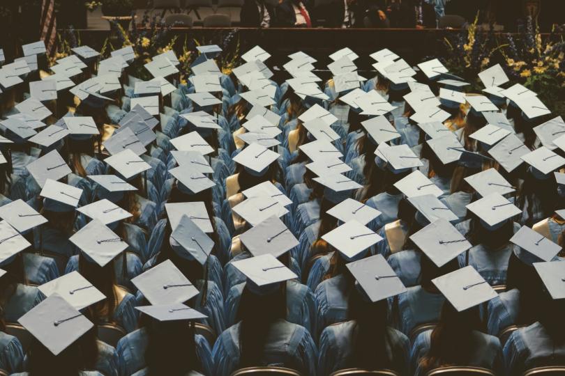 Rows of graduation caps seen from above. 