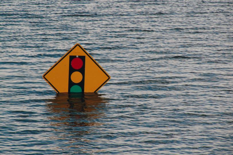 A street sign pokes out of flood waters