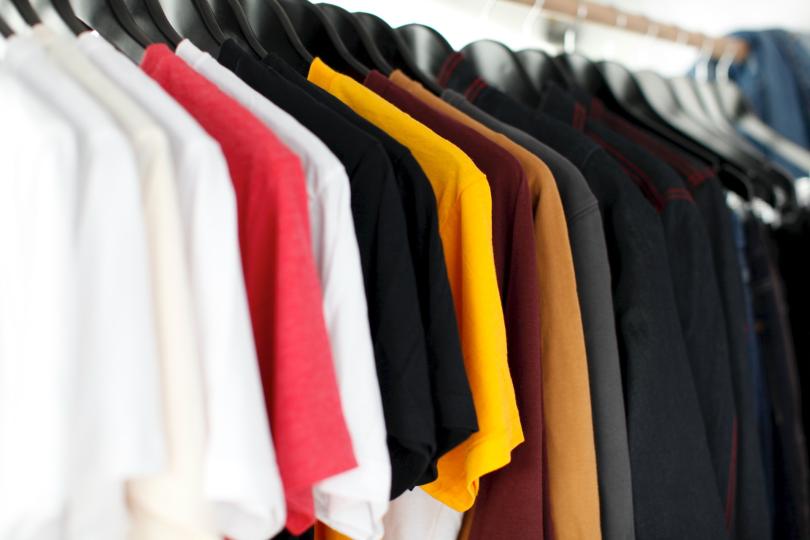 A rack of t shirts on hangers