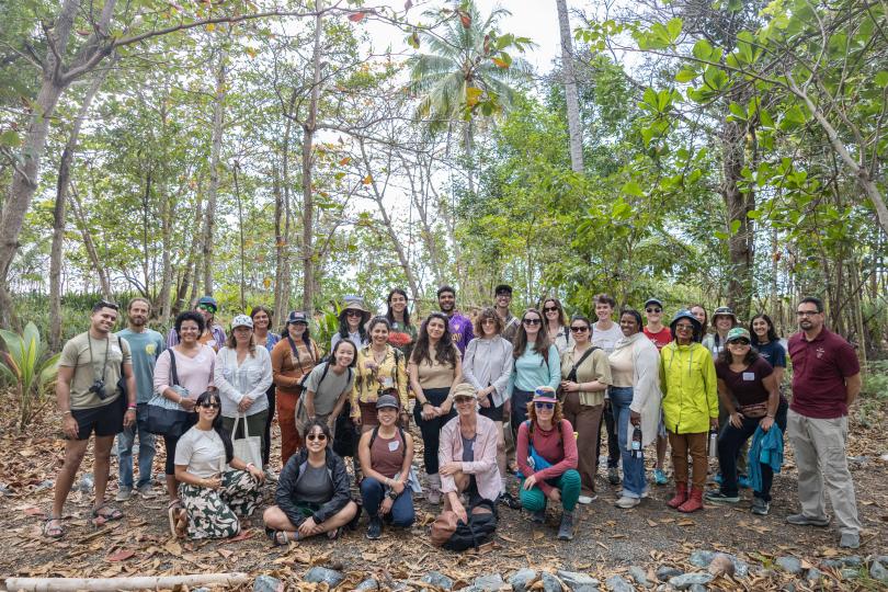 A group photo of Fellowship to Friendship participants standing in the forest.