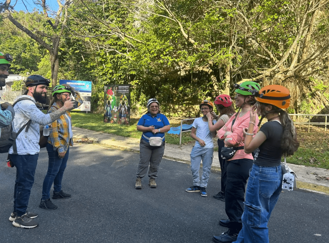 Tourists stand listening to a guide from Las Cabachuelas.