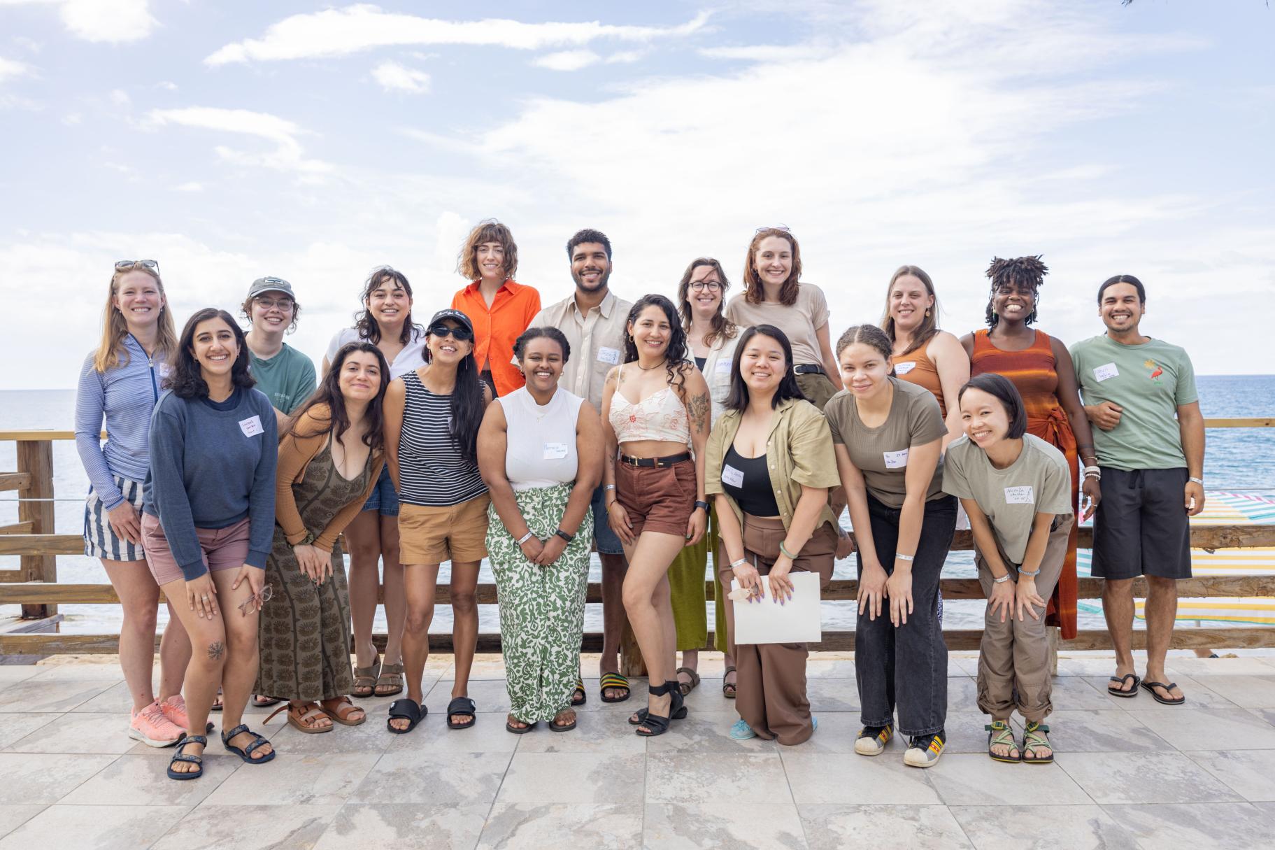 A group photo of the 2024 Switzer Fellows on a patio overlooking the ocean.